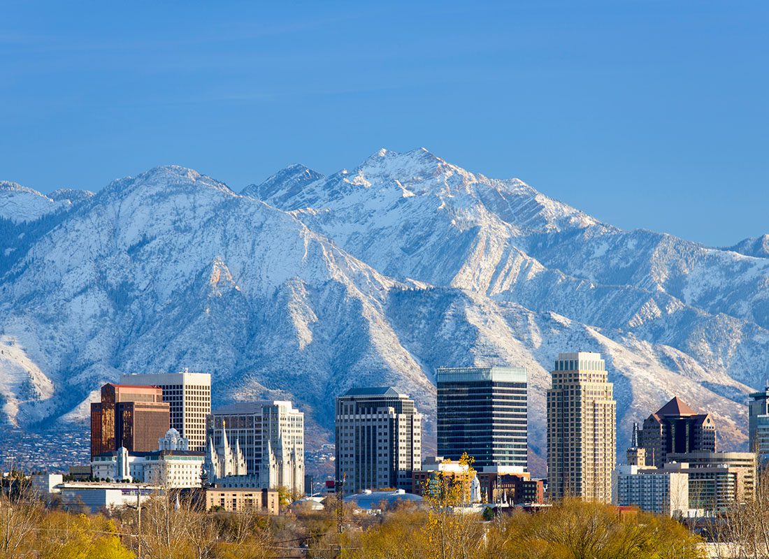 Contact - Aerial View of Salt Lake City Skyline With Mountains Behind on a Sunny Day